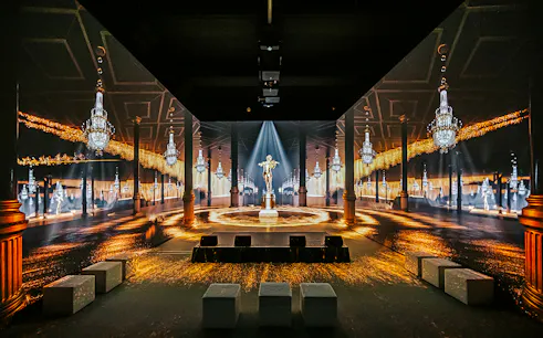 Vienna: Johann Strauss Museum immersive exhibit with chandeliers and statue.