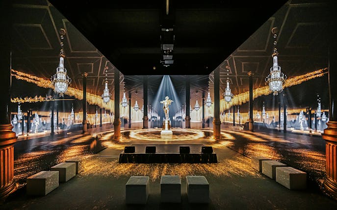 Vienna: Johann Strauss Museum immersive exhibit with chandeliers and statue.