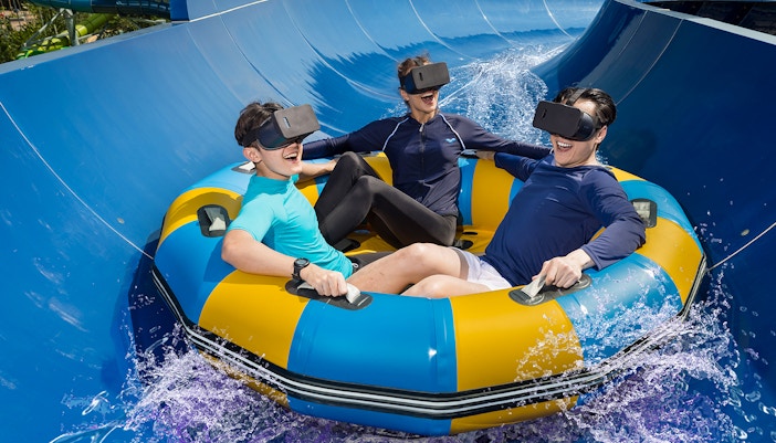 People wearing VR headset sliding on a ride in Splash Mania Waterpark at Gamuda Cove
