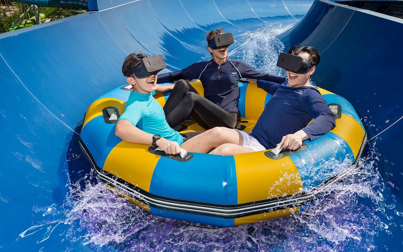 People wearing VR headsets on a water ride at Splash Mania Waterpark, Gamuda Cove.