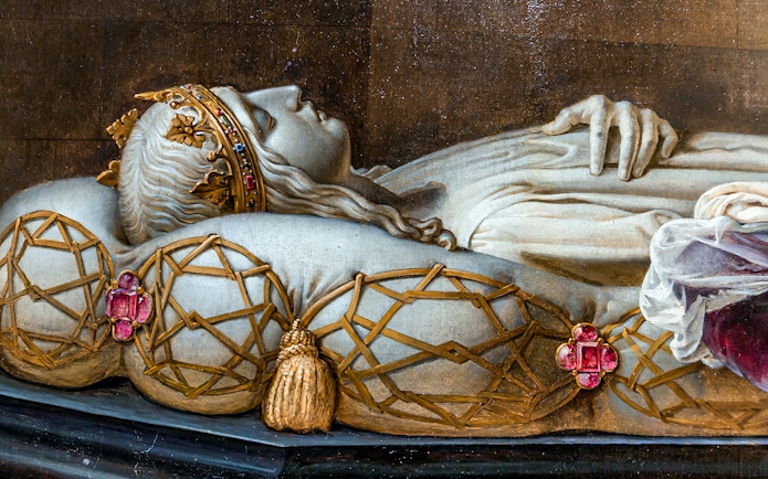 Royal tomb effigy at Blois Castle, France, showcasing intricate crown and pillow details.