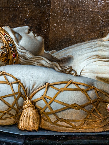 Royal tomb effigy at Blois Castle, France, showcasing intricate crown and pillow details.