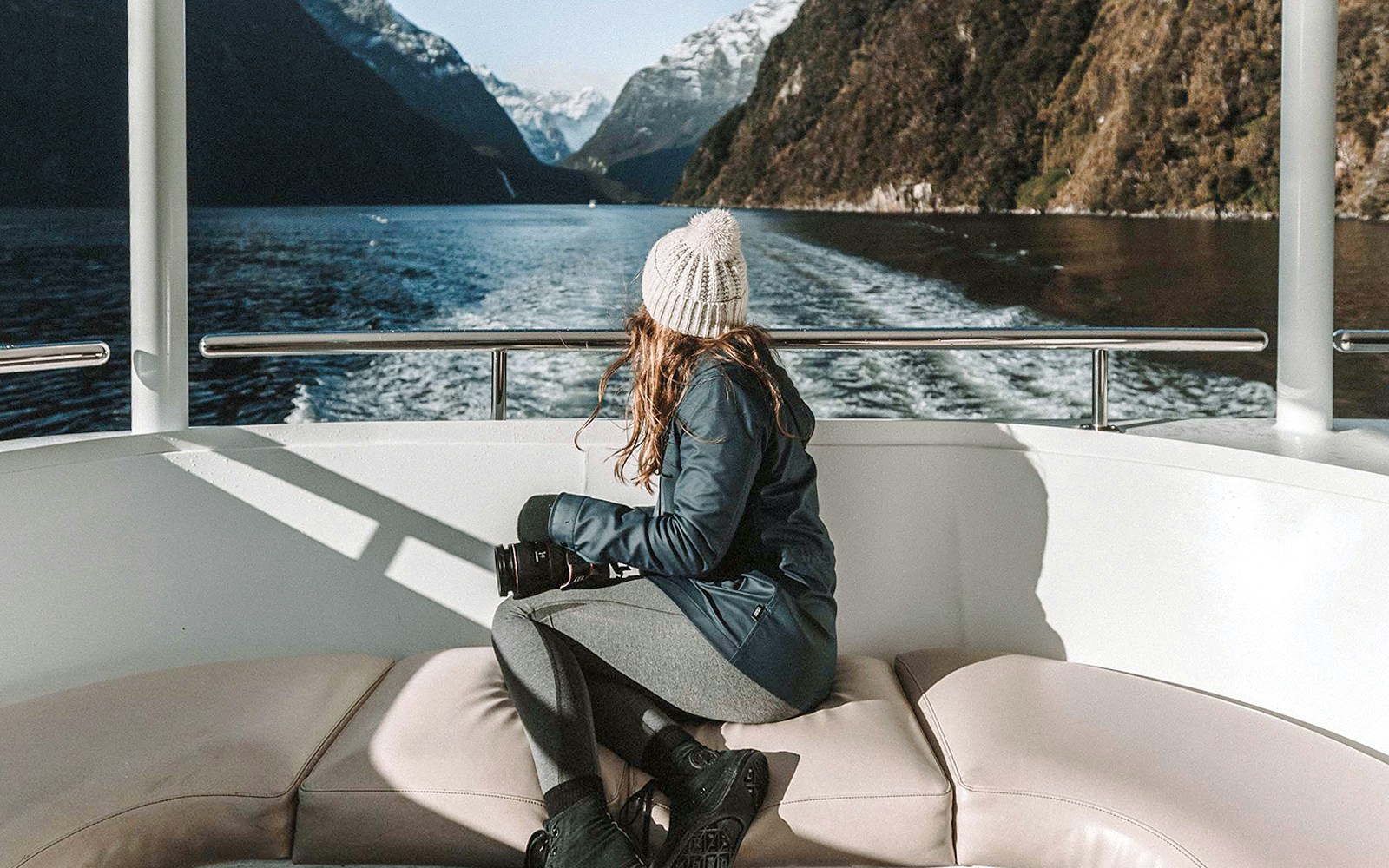 Milford Sound cruise with scenic mountain views and lush greenery, Queenstown day trip.