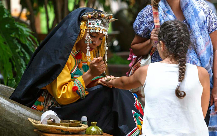 Henna artist applying design at Agadir Crocoparc.