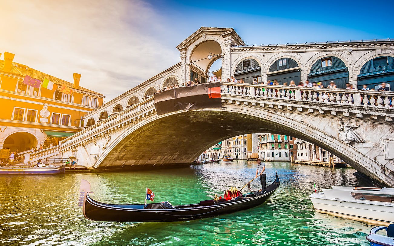 Gondola on Grand Canal near Rialto Bridge, Venice, during full-day tour from Lake Garda.