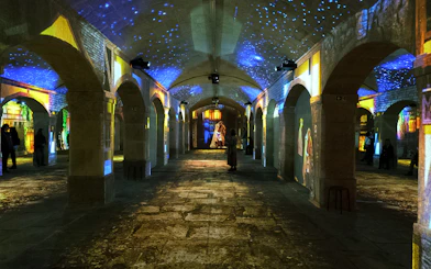 Porto Legends immersive experience with projections in a historic stone hall.
