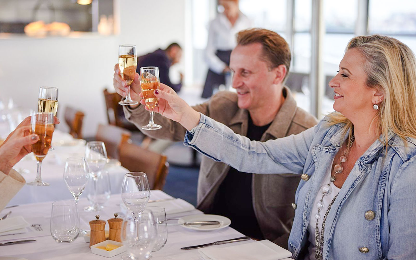 Tourists toasting with champagne on a Sydney Harbour cruise.