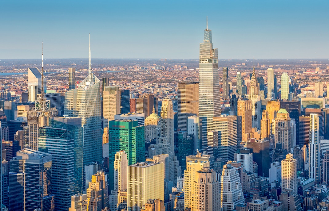New York skyline with iconic skyscrapers at sunset.