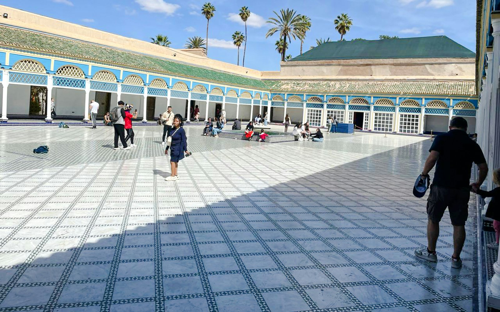 Visitors in the courtyard of Bahia Palace, Marrakech, Morocco.