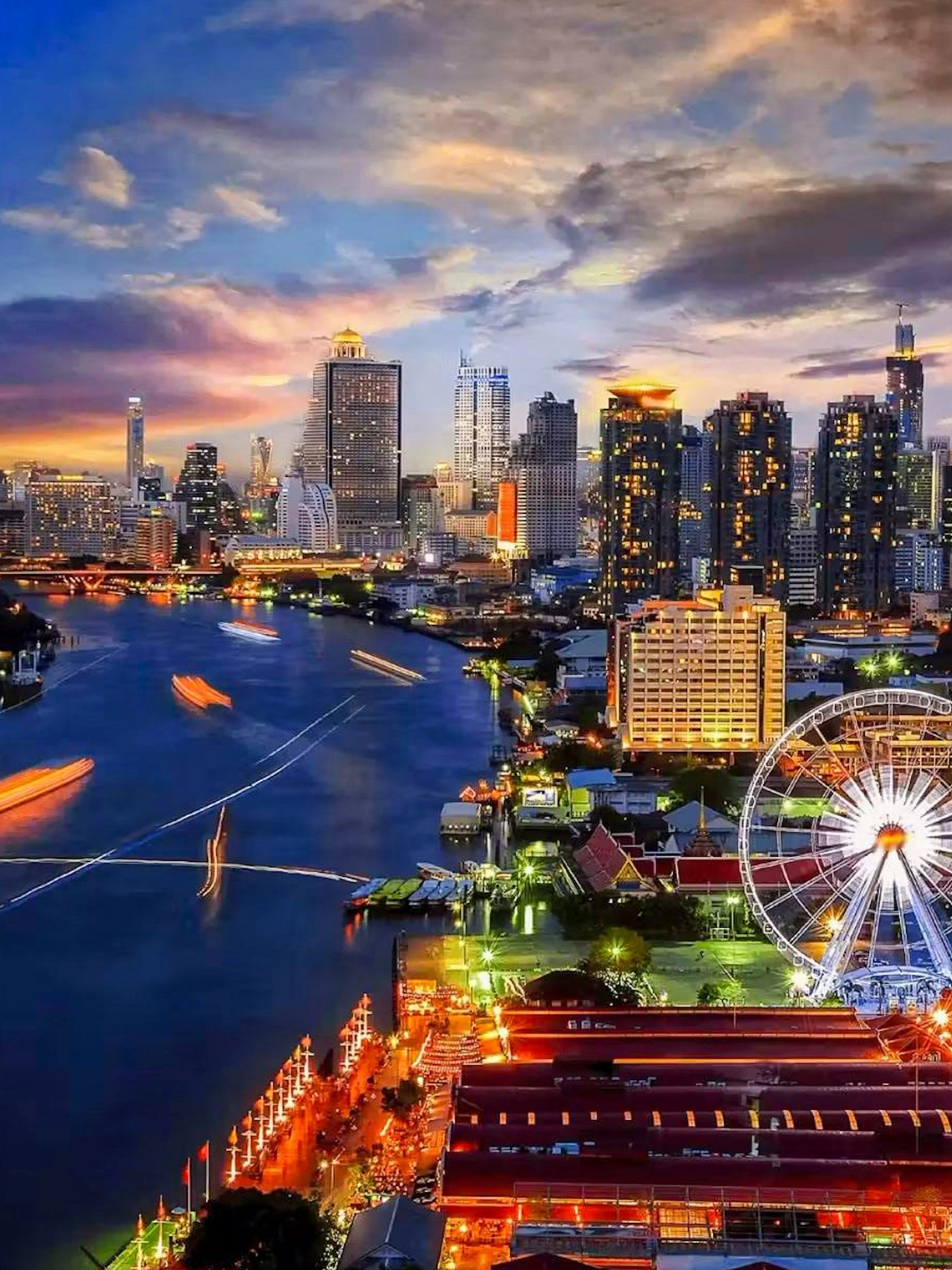 Sunset view of Asiatique Sky Ferris wheel at Asiatique The Riverfront in Bangkok, Thailand.