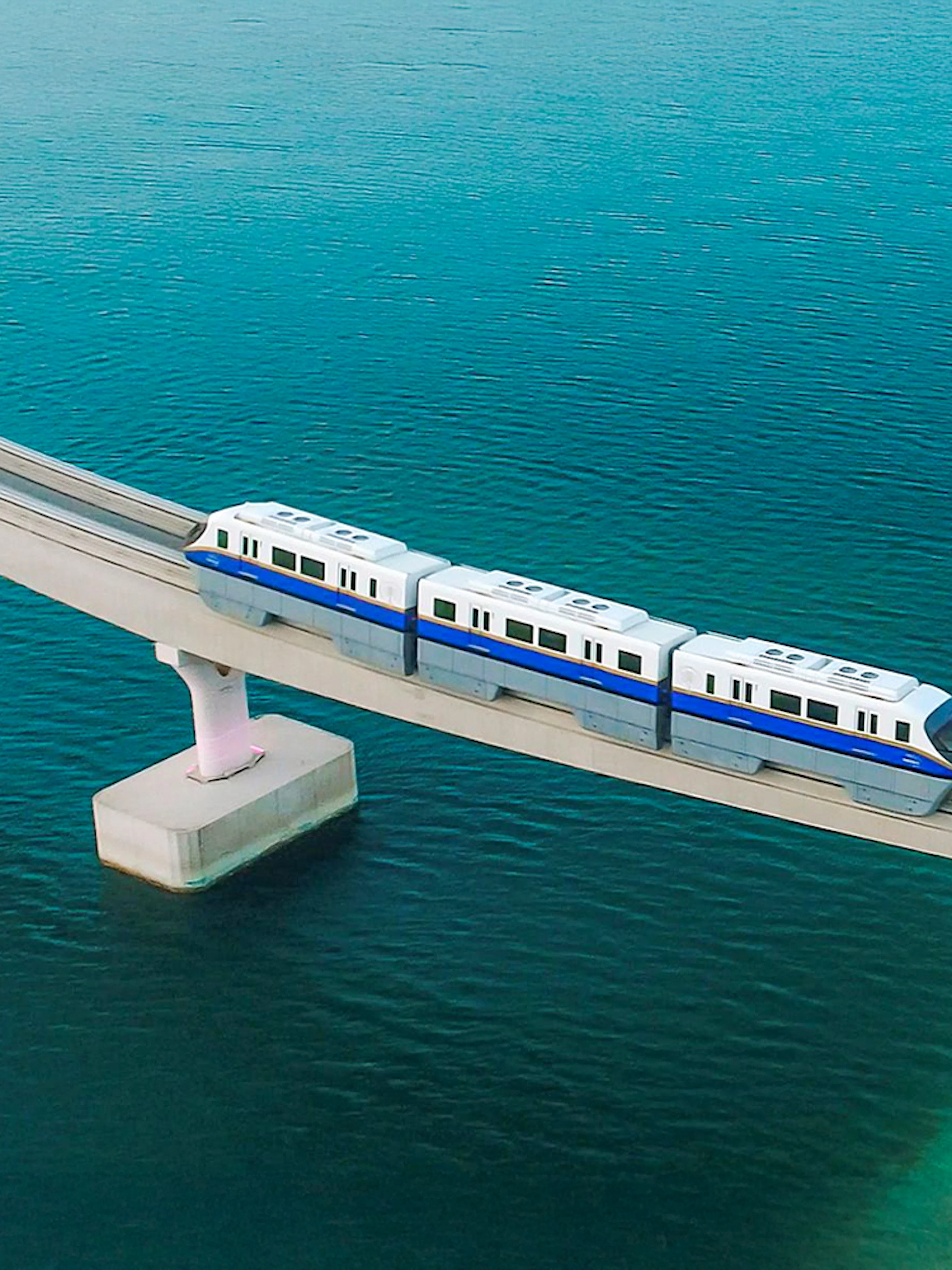 Palm Jumeirah Monorail crossing bridge over water in Dubai.