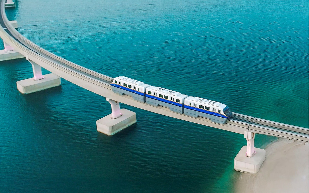 Palm Jumeirah Monorail crossing bridge over water in Dubai.