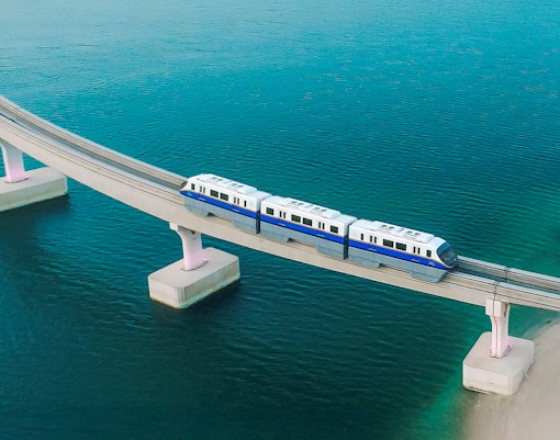 Palm Jumeirah Monorail crossing bridge over water in Dubai.