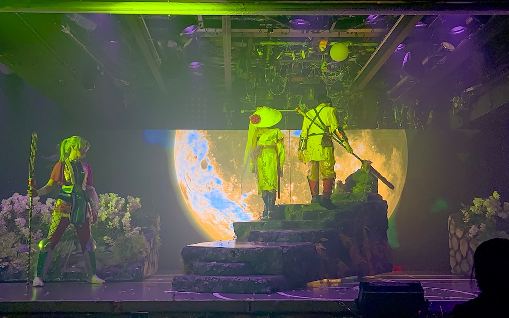Samurai performers on stage with moon backdrop at Samurai Restaurant Show.