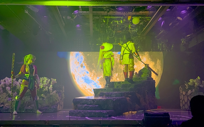 Samurai performers on stage with moon backdrop at Samurai Restaurant Show.