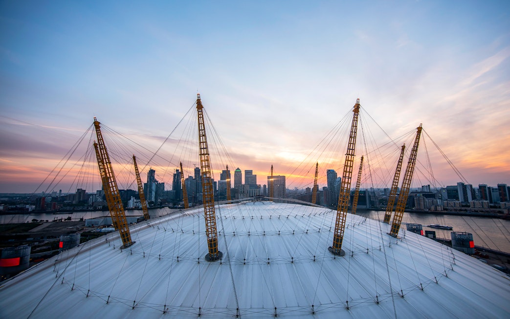 Guests enjoying sunset view at The O2 Arena, London, with city skyline in the background.