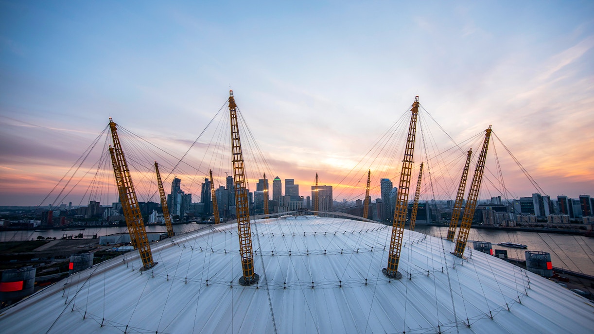 Guests enjoying sunset view at The O2 Arena, London, with city skyline in the background.
