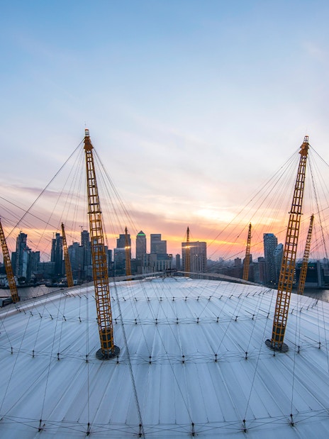 Guests enjoying sunset view at The O2 Arena, London, with city skyline in the background.