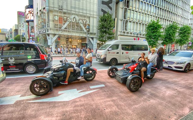 Go-kart riders in Shibuya, Tokyo, with Tsutaya building in the background.