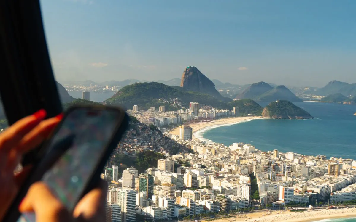 Aerial view of Sugarloaf Mountain and Copacabana Beach during Rio de Janeiro helicopter tour.