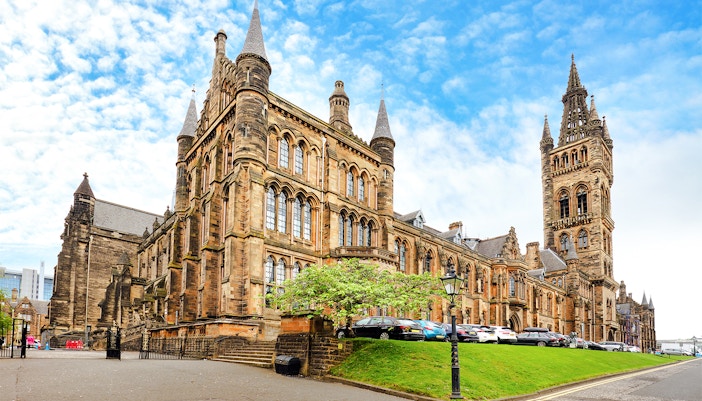 University of Glasgow Main Building with Gothic architecture and tall spire.