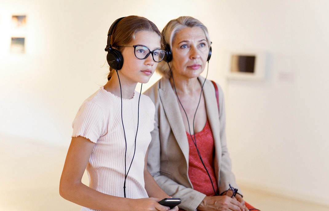 Tourists using audioguides at the Louvre Museum in Paris, France.