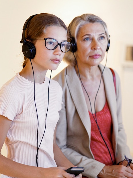 Tourists using audioguides at the Louvre Museum in Paris, France.