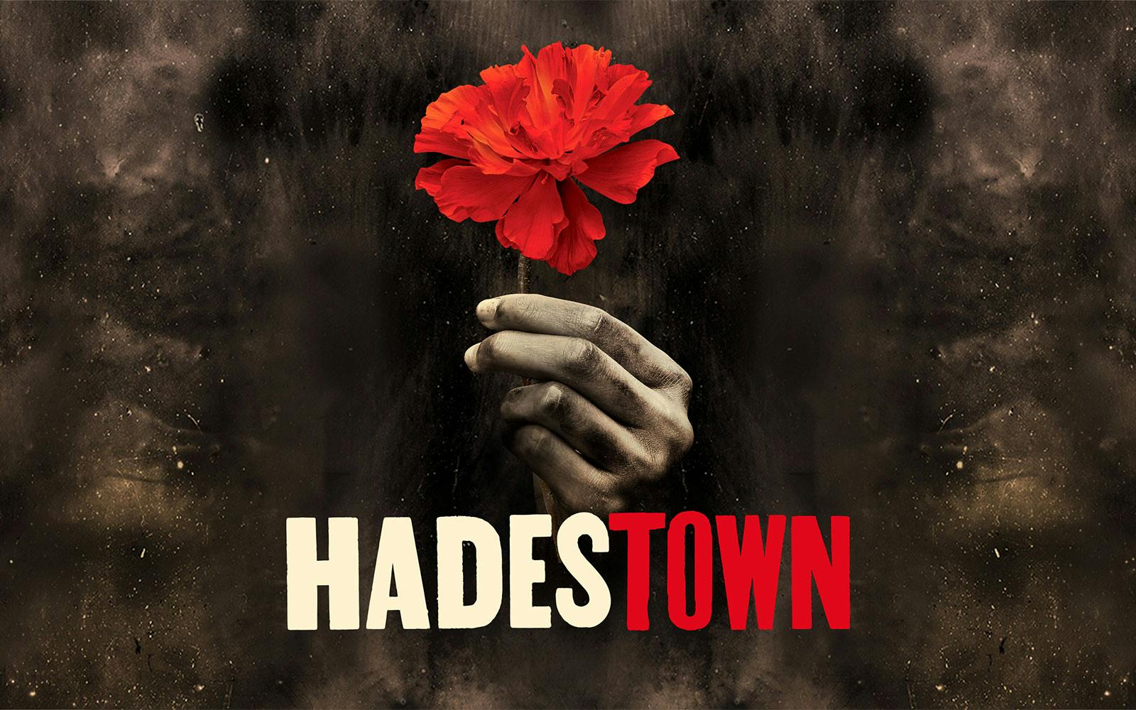 Hand holding a red flower with "Hadestown" text, West End production.