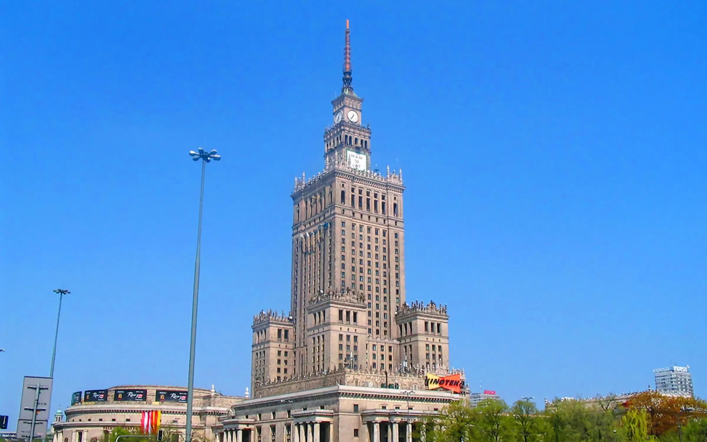Palace of Culture and Science in Warsaw under a clear blue sky.
