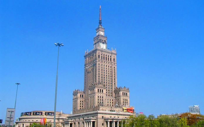 Palace of Culture and Science in Warsaw under a clear blue sky.