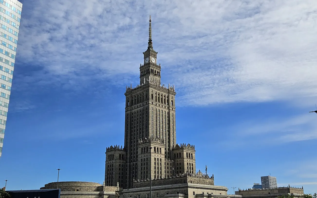 Palace of Culture and Science in Warsaw under a blue sky.