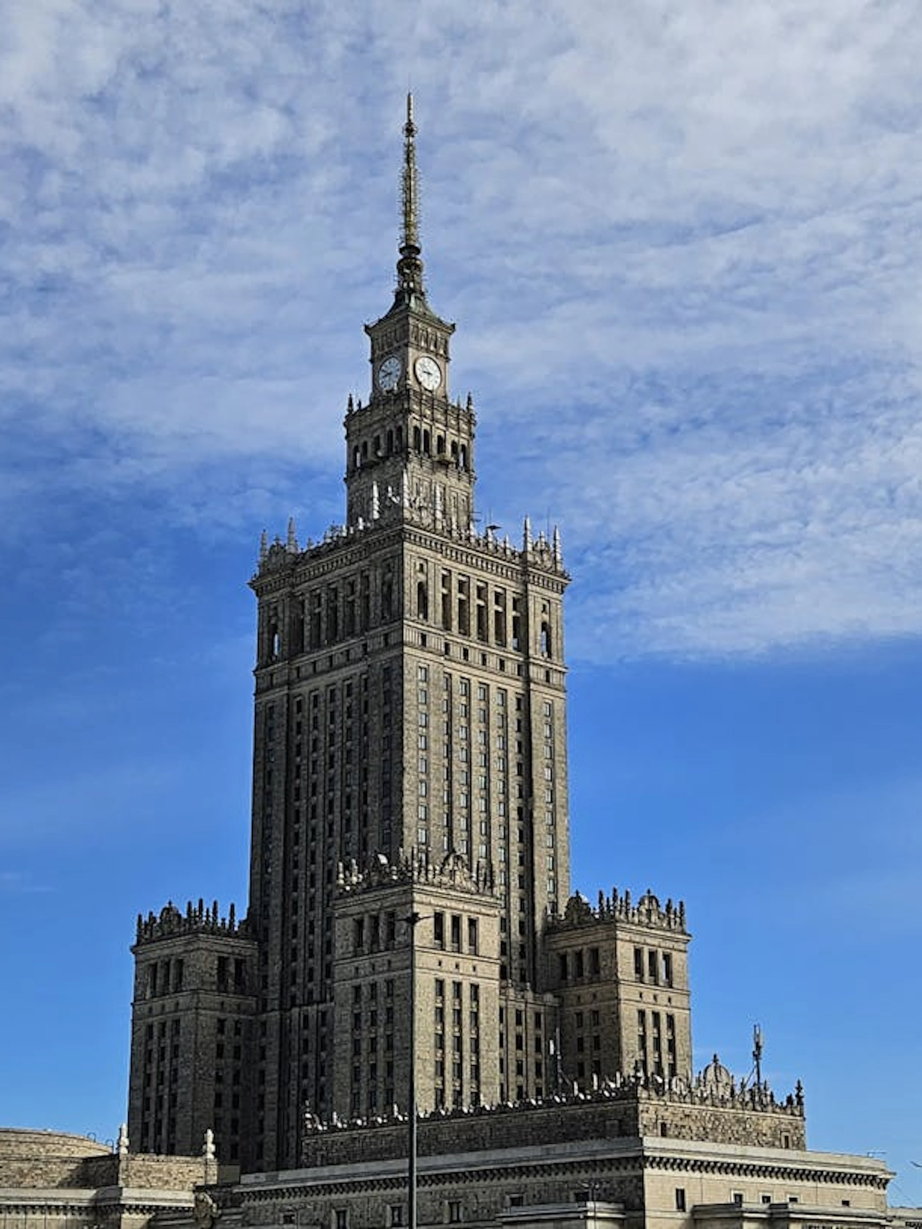 Palace of Culture and Science in Warsaw under a blue sky.