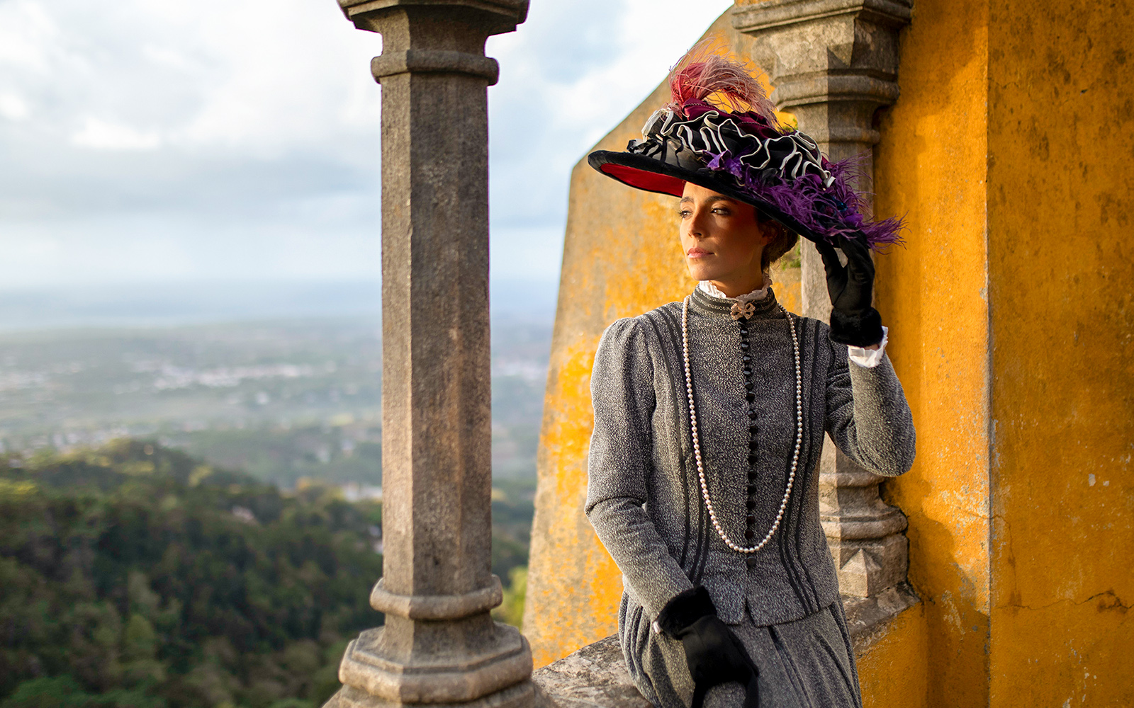 Person in period costume at Palace of Pena, Sintra, Portugal, during theatrical tour.