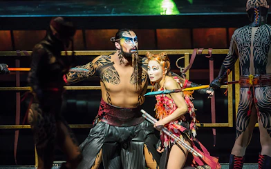 Performers in elaborate costumes during Cirque du Soleil KÀ show.