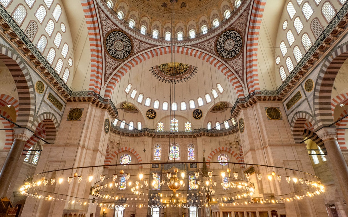 Interior of Blue Mosque with ornate domes and stained glass windows, Istanbul.
