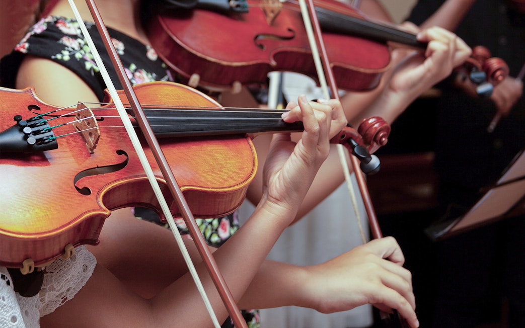 Musicians playing violins at Lobkowicz Palace midday concert.