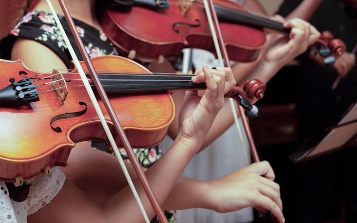 Musicians playing violins at Lobkowicz Palace midday concert.