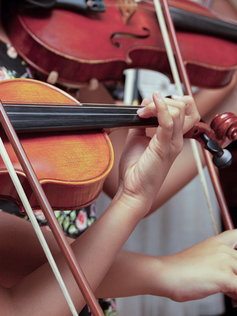 Musicians playing violins at Lobkowicz Palace midday concert.