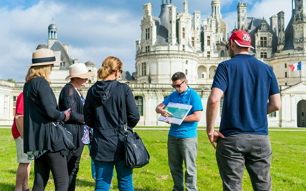 Tour group with guide at Château de Chambord in Loire Valley.