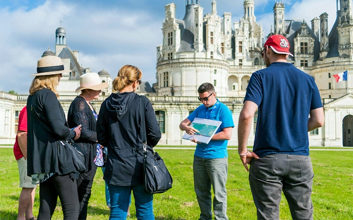 Tour group with guide at Château de Chambord in Loire Valley.