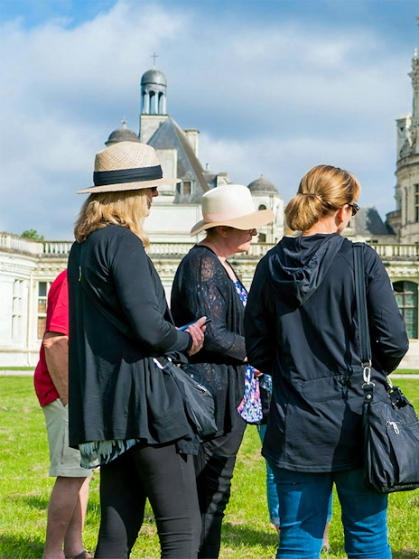 Tour group with guide at Château de Chambord in Loire Valley.
