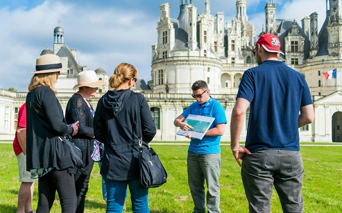 Tour group with guide at Château de Chambord in Loire Valley.