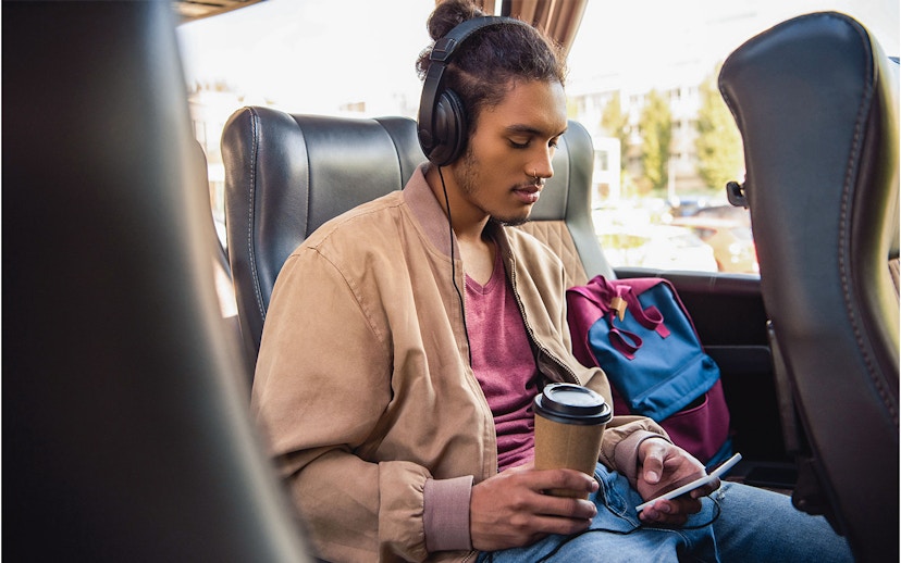 Passenger using wifi and enjoying a drink on a bus from Naples Metropark to Rome Tiburtina.