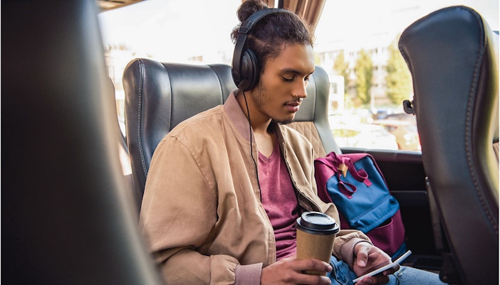 Bus interior with passengers seated, enjoying WiFi and drinks on route from Naples Metropark to Rome Tiburtina.