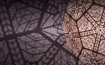 Intricate geometric patterns casting shadows in Kuala Lumpur exhibit.