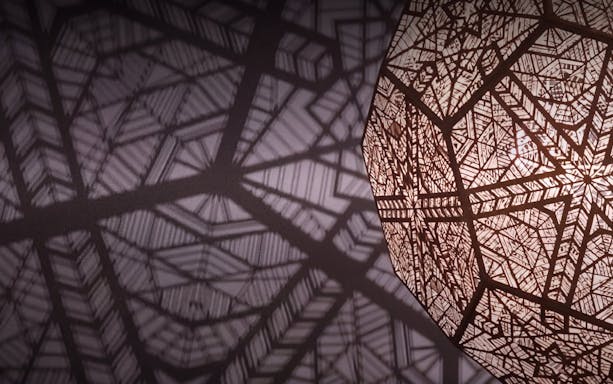 Intricate geometric patterns casting shadows in Kuala Lumpur exhibit.