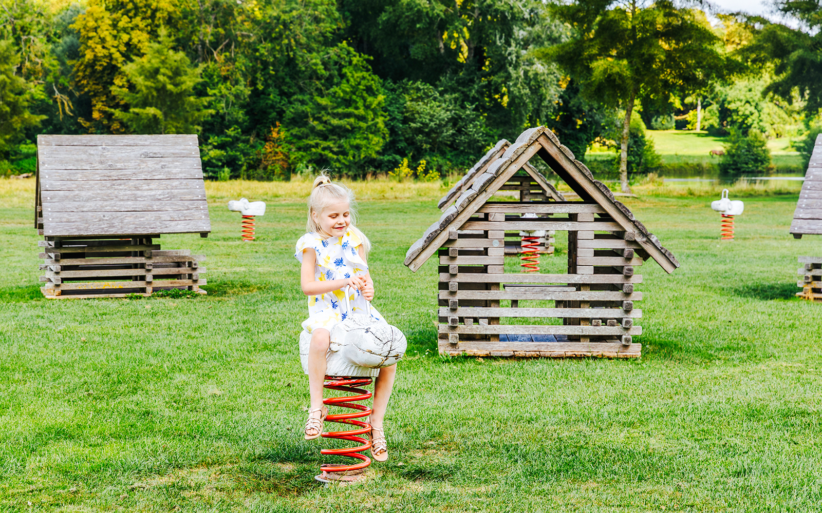 Child playing on a spring rider at Chateau of Chantilly playground.