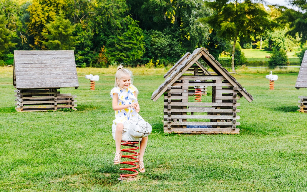 Child playing on a spring rider at Chateau of Chantilly playground.