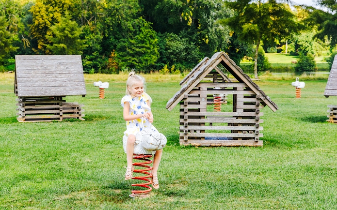 Child playing on a spring rider at Chateau of Chantilly playground.