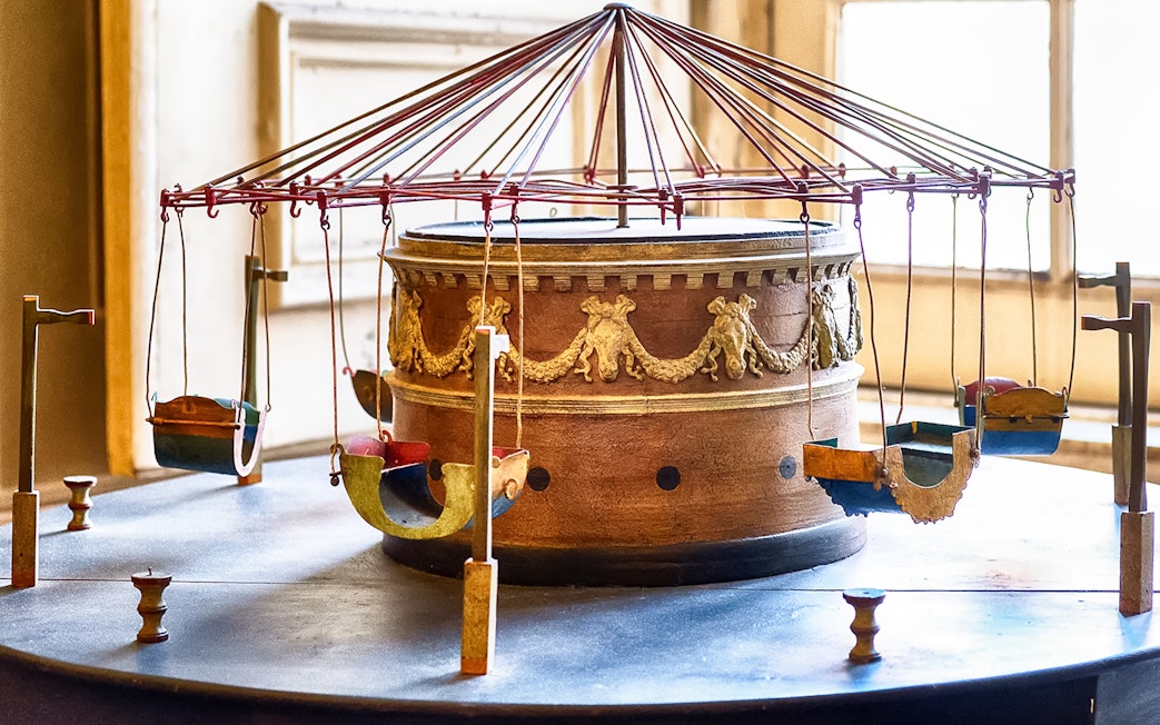 Ancient carousel model at Royal Palace of Caserta with ornate design.